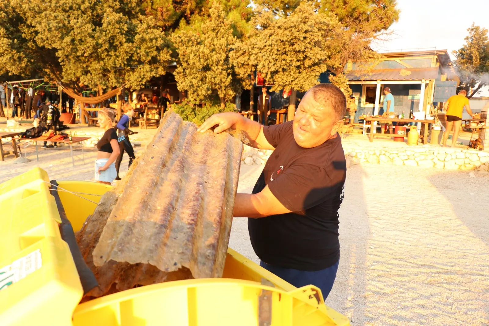 Divers and locals on a seabed cleanup