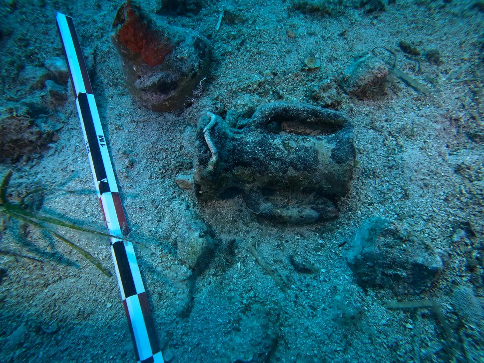 Amphora with a measuring stick on the seabed
