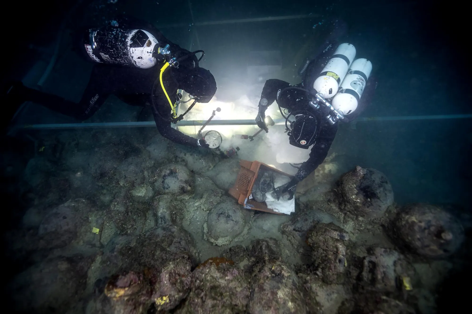 Two divers documenting an amphora site on the seabed